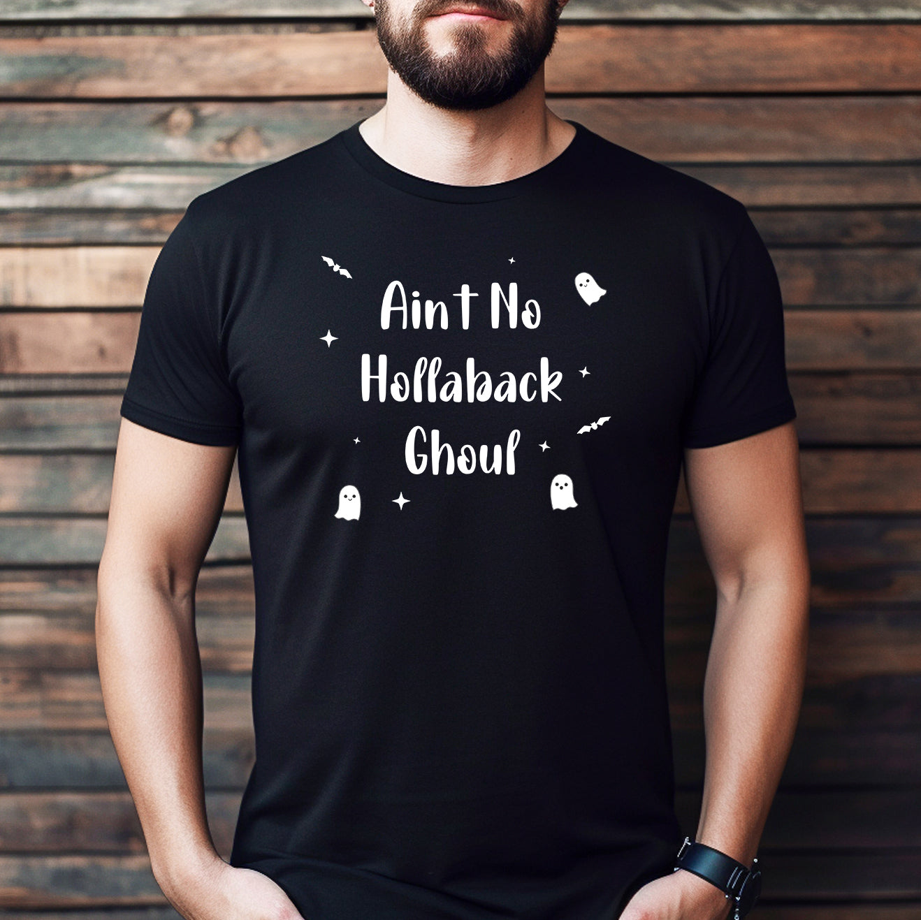 Man wearing a black Ain’t No Hollaback Ghoul t-shirt with white Halloween design featuring ghosts, bats, and stars.