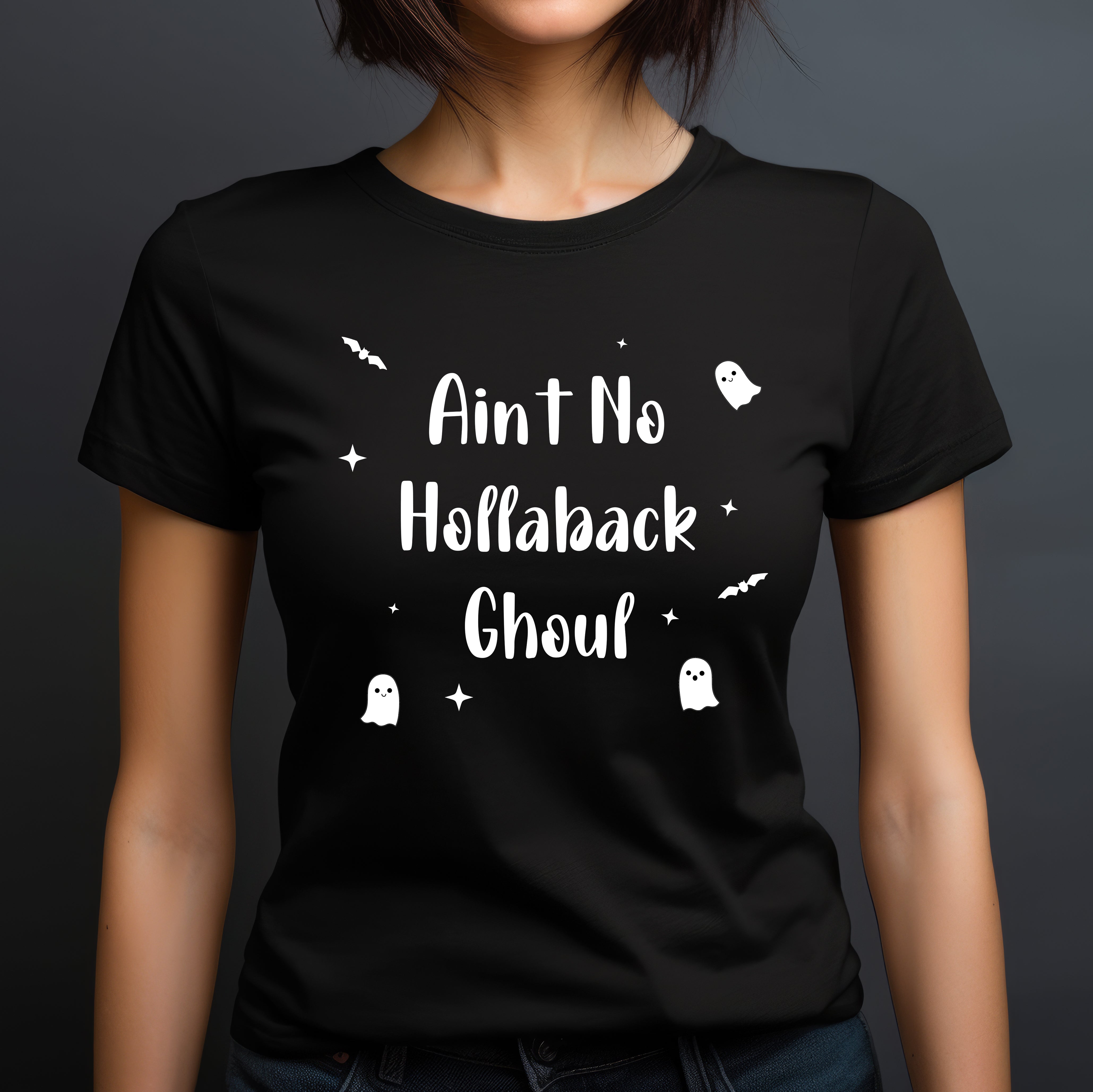 Woman in black crew neck t-shirt featuring the phrase Ain’t No Hollaback Ghoul with playful white Halloween-themed graphics.
