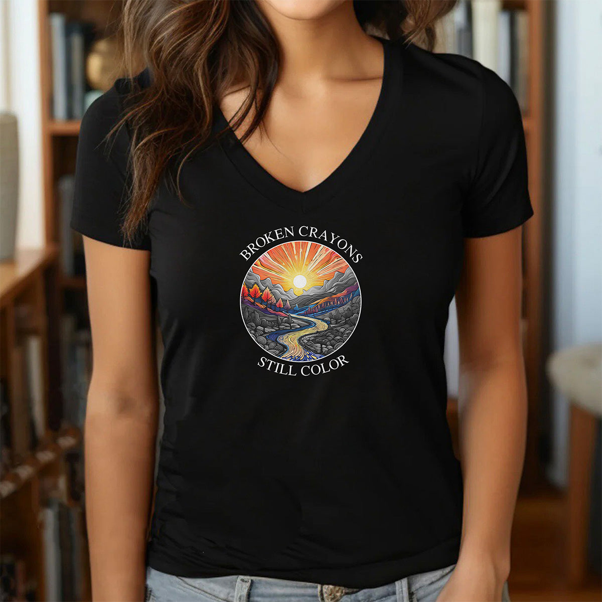 Women’s black v-neck t-shirt with broken crayons still color quote and vibrant sunrise mountain graphic
