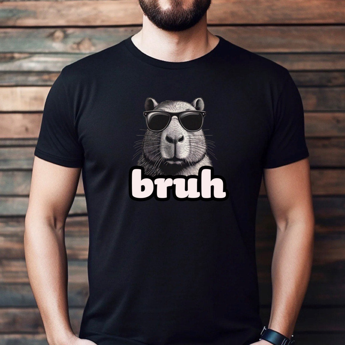 Man wearing black capybara bruh meme t-shirt with sunglasses graphic, casual lifestyle background