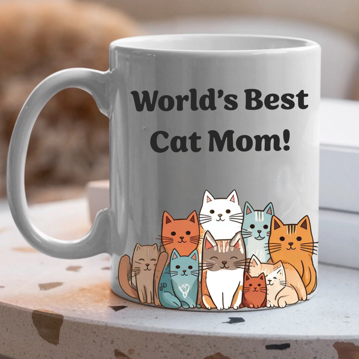White ceramic cat mom mug on table with colorful cartoon cat design perfect gift for cat lovers