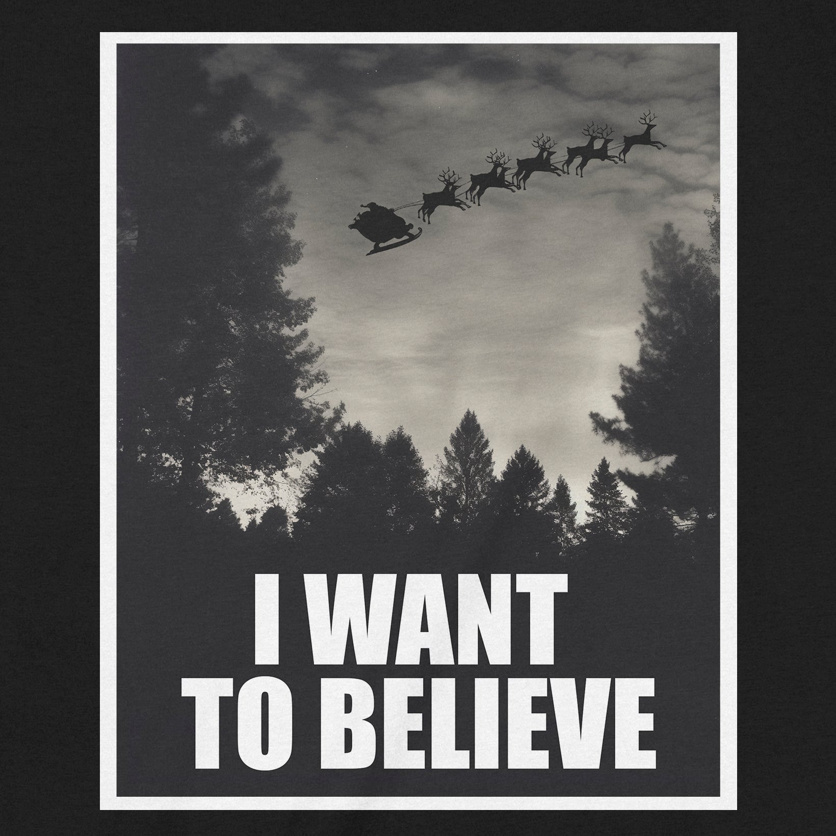 Closeup of Santa I Want to Believe graphic tee with sleigh silhouette in night sky