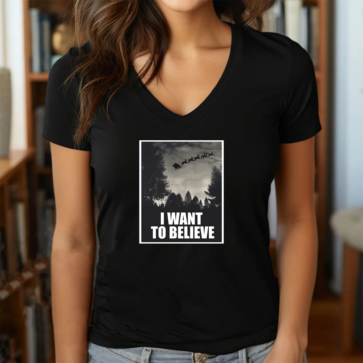 Women’s v-neck Christmas graphic t-shirt in black with Santa sleigh I Want to Believe design