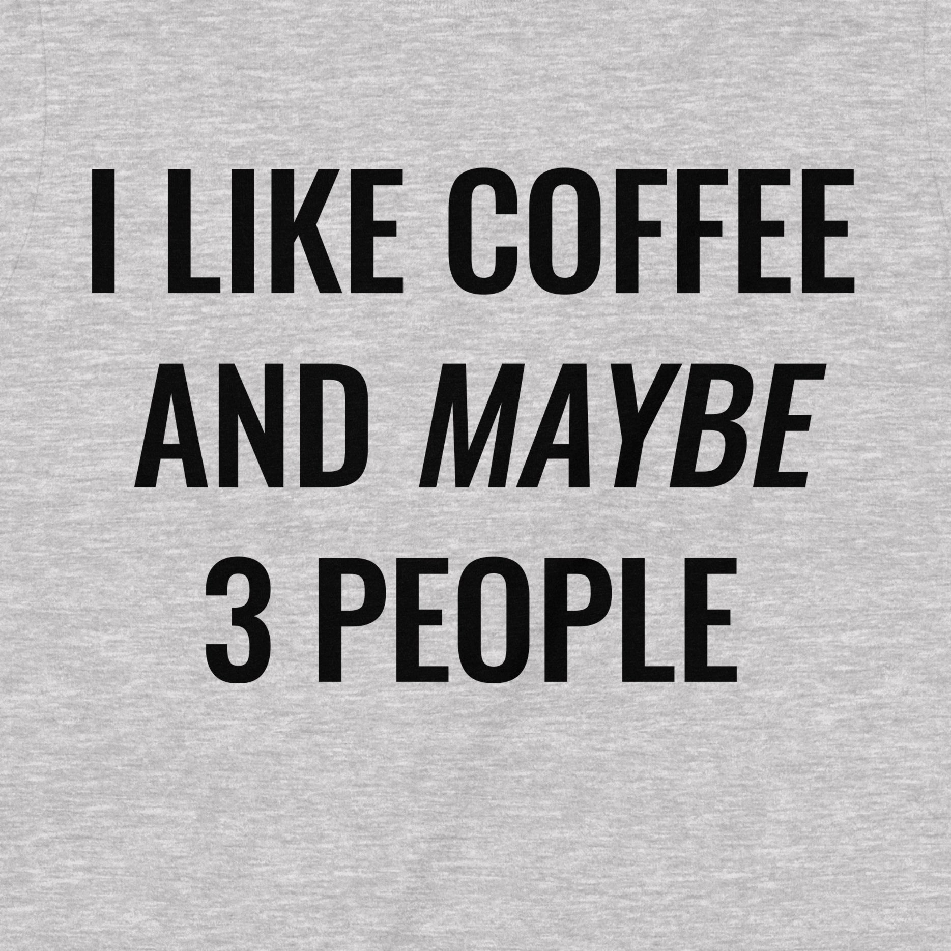 Close-up view of grey t-shirt text design that reads I like coffee and maybe 3 people