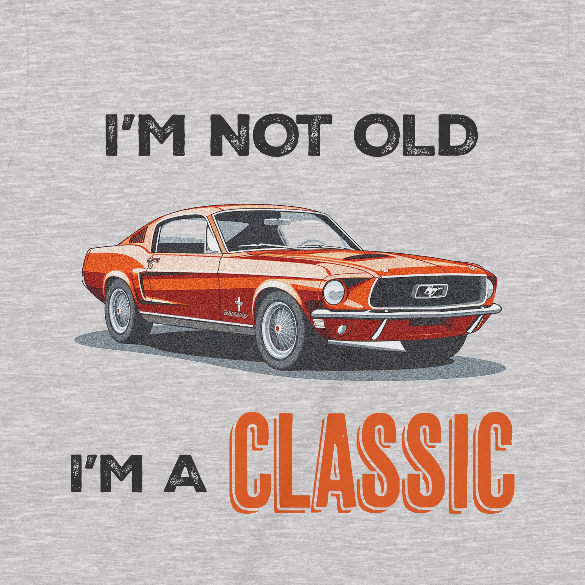 Closeup of vintage orange car graphic and distressed text I’m not old I’m a classic on heather gray fabric