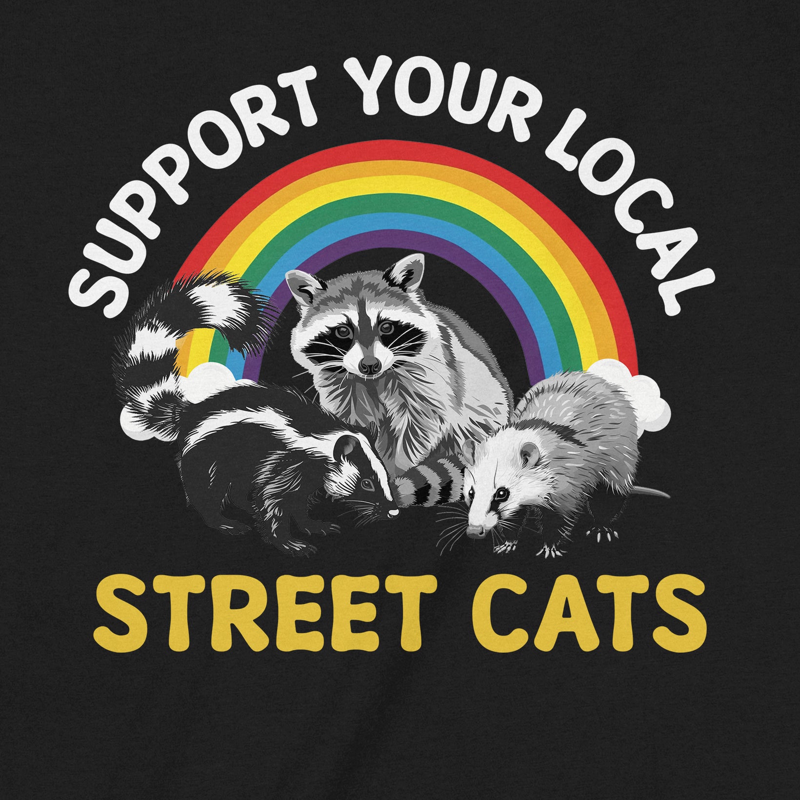 Closeup of black shirt with raccoon and possum graphic under rainbow text Support Your Local Street Cats