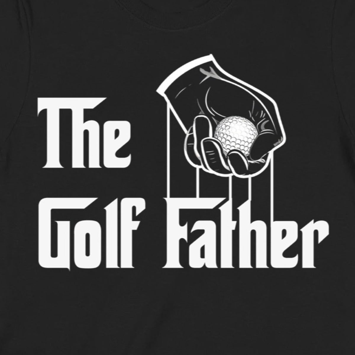 Closeup of The Golf Father text with hand holding golf ball graphic on black t-shirt