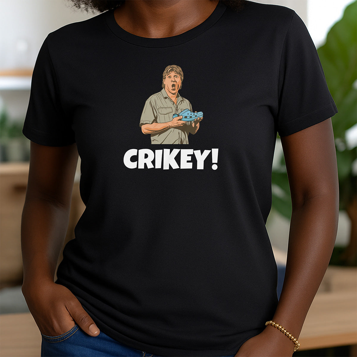 Woman in black crewneck Crikey t-shirt with humorous cartoon man holding crocodile design
