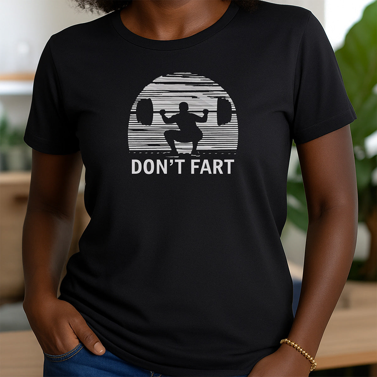 Women's black crewneck t-shirt featuring squat weightlifting graphic with bold text don't fart