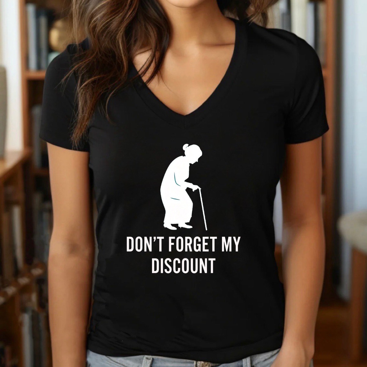 Woman wearing black v-neck tee with white elderly woman silhouette and Don’t forget my discount quote, indoor lifestyle