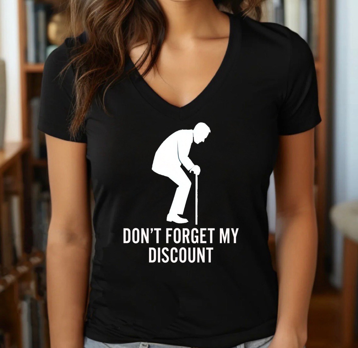 Woman wearing black v-neck tee with white senior silhouette and Don’t forget my discount quote, indoor lifestyle