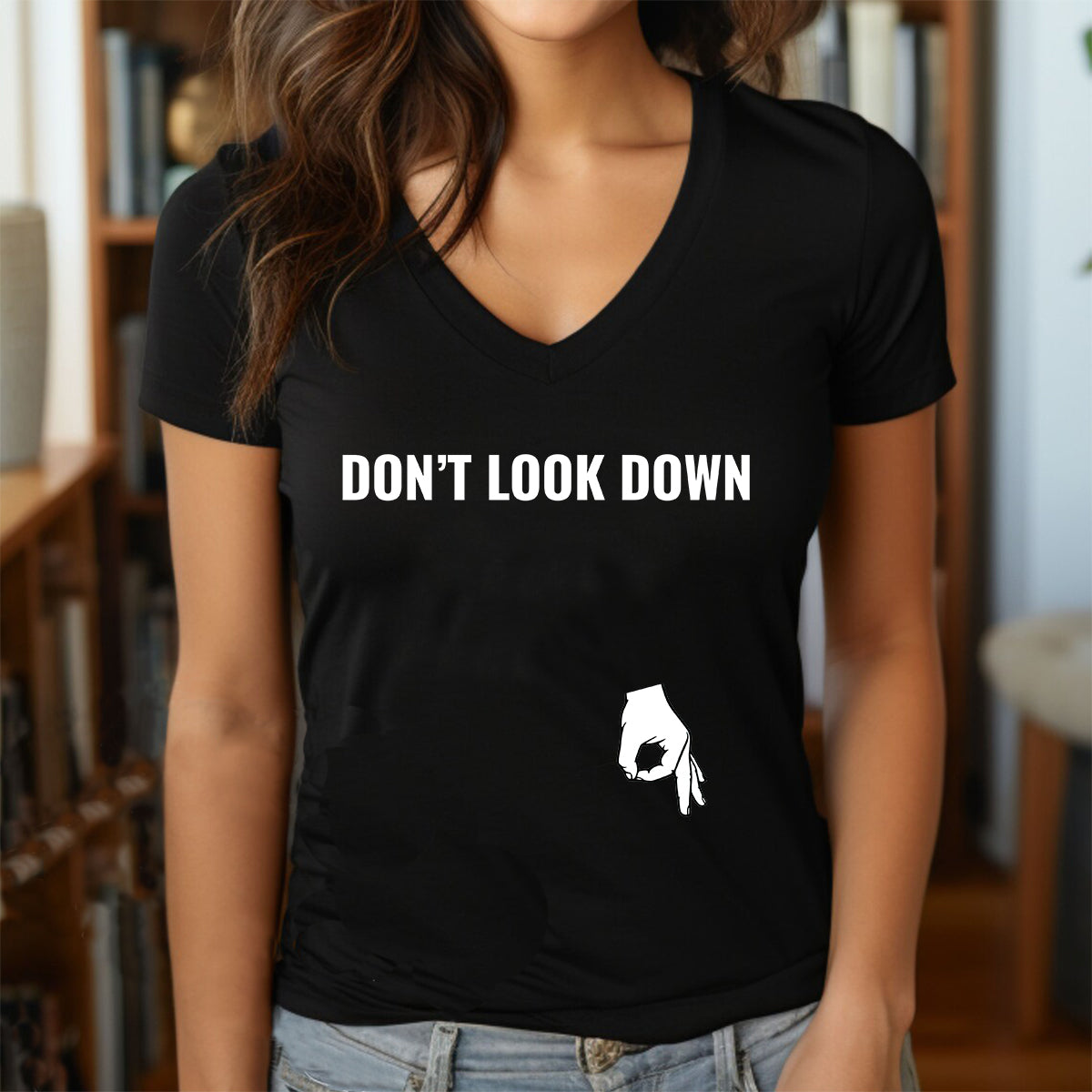 woman wearing black v neck shirt with dont look down text and hand circle game graphic near hip