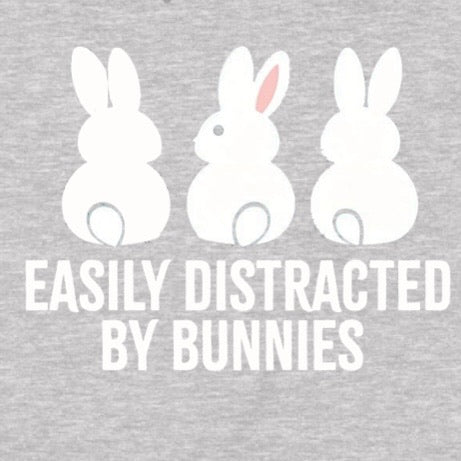Closeup of gray shirt design with three cartoon bunnies and text easily distracted by bunnies