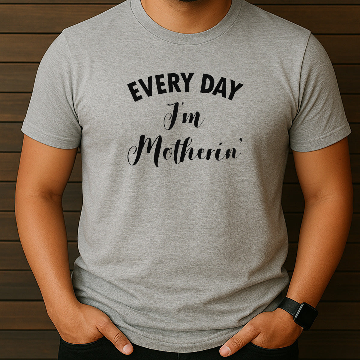 Man wearing grey t-shirt with Every Day I'm Motherin' design in black lettering