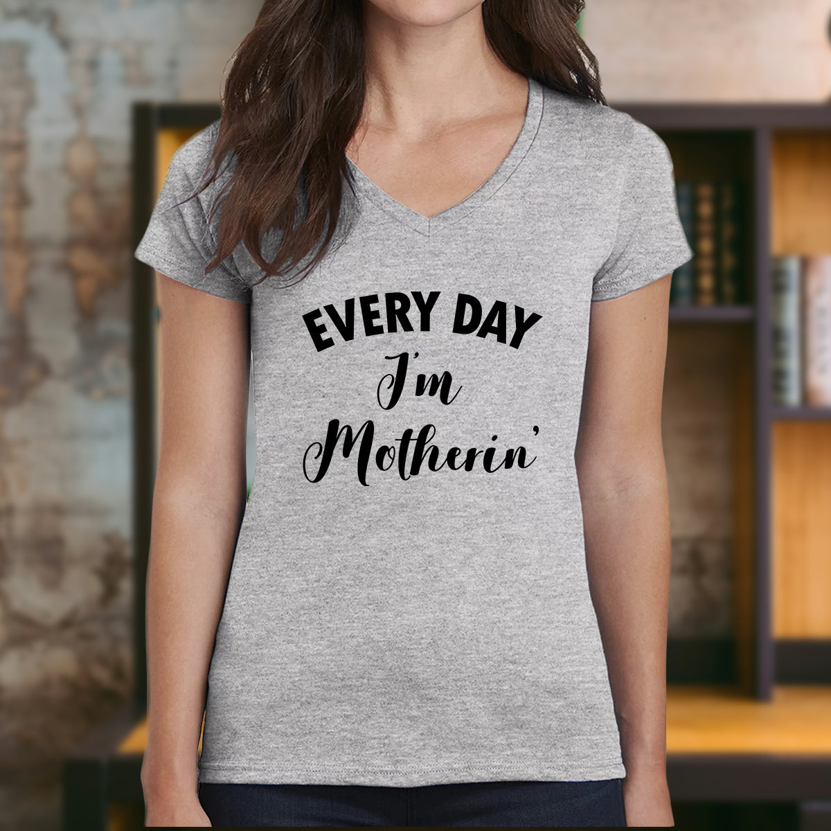 Grey women’s v-neck t-shirt with the phrase Every Day I'm Motherin' printed in black text