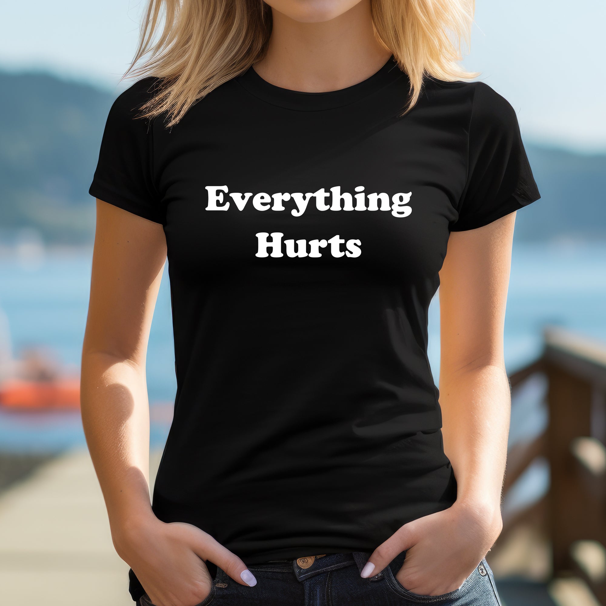 Woman wearing fitted black "Everything Hurts" graphic tee outdoors, funny casual women’s shirt.