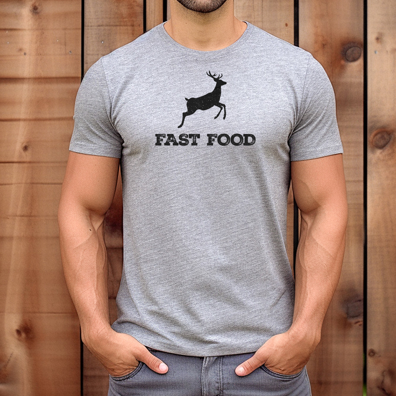 Man wearing grey t-shirt with hunting humor design of deer silhouette and fast food text