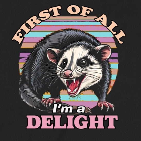 Closeup of snarling opossum with retro sunset stripes and text First of all I’m a delight on black tee