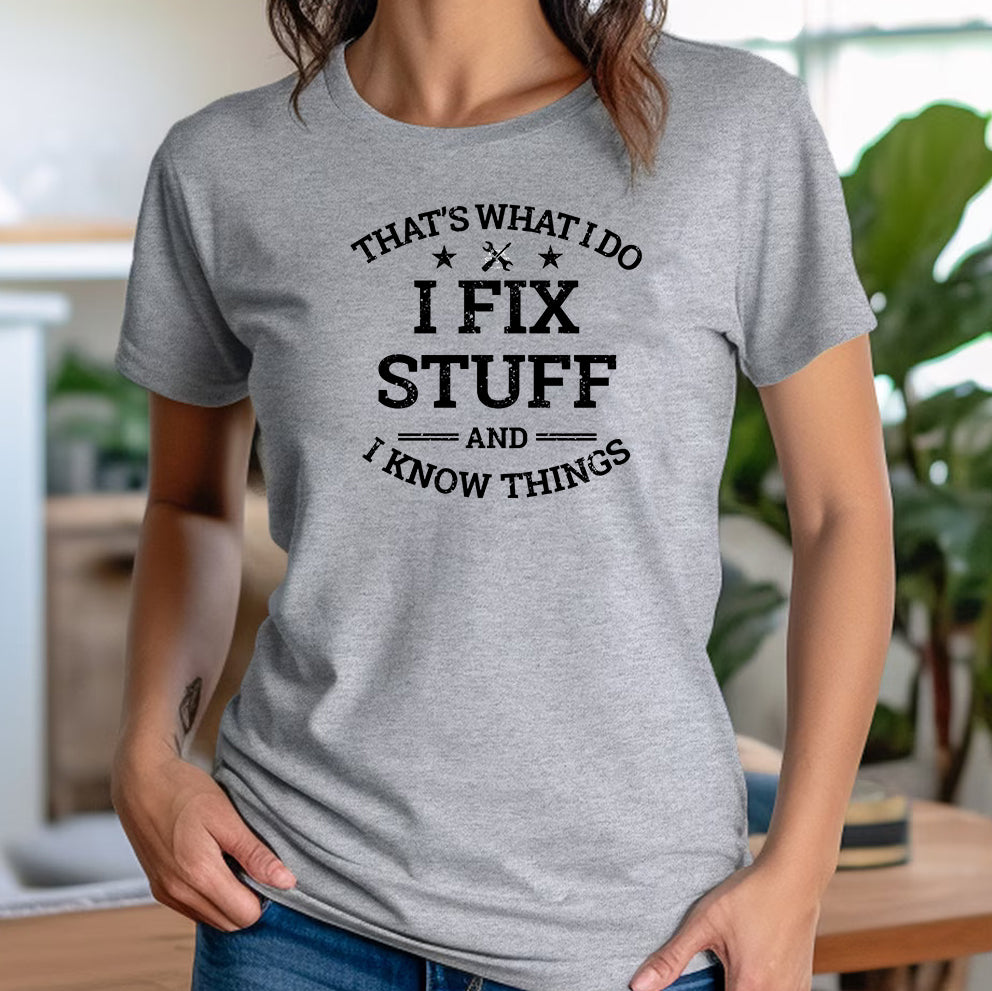 Woman in casual setting wearing grey crew neck t-shirt with black text I Fix Stuff And I Know Things