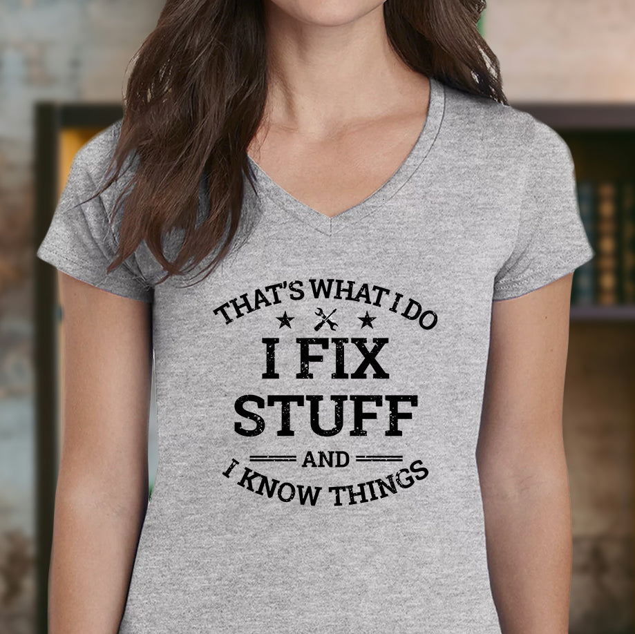 Woman wearing grey v-neck t-shirt with black lettering I Fix Stuff And I Know Things indoors