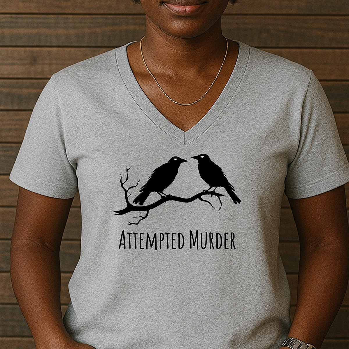 Women’s gray v-neck shirt with two crows on branch and Attempted Murder slogan, funny bird pun tee for witty casual style