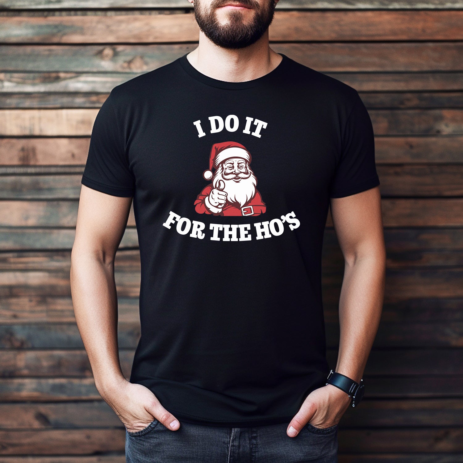 Person wearing a black t-shirt with a Santa Claus graphic and text against a wooden background