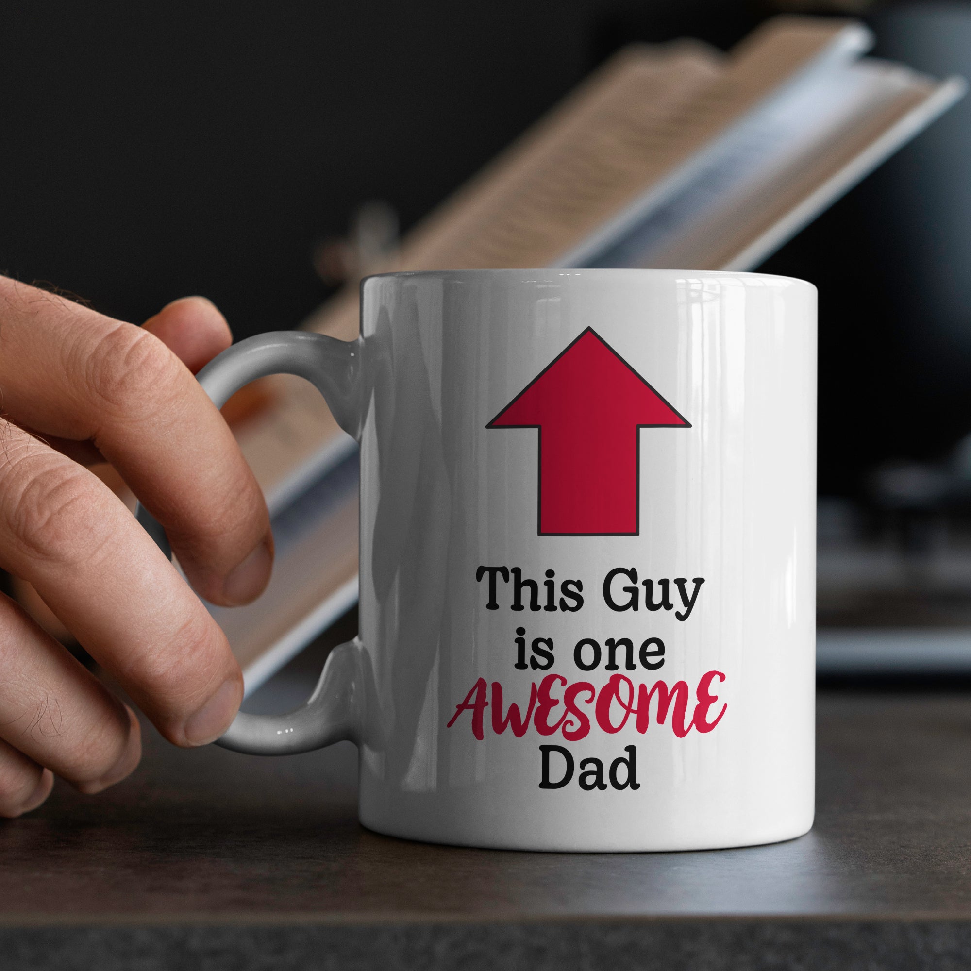 White ceramic dad mug with hand on handle Awesome Dad text, humorous 15oz gift on table 
