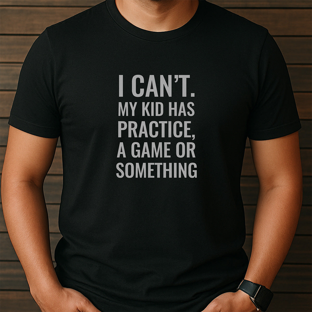 Man wearing black t-shirt with I Can’t My Kid Has Practice Game Or Something funny quote for busy parents