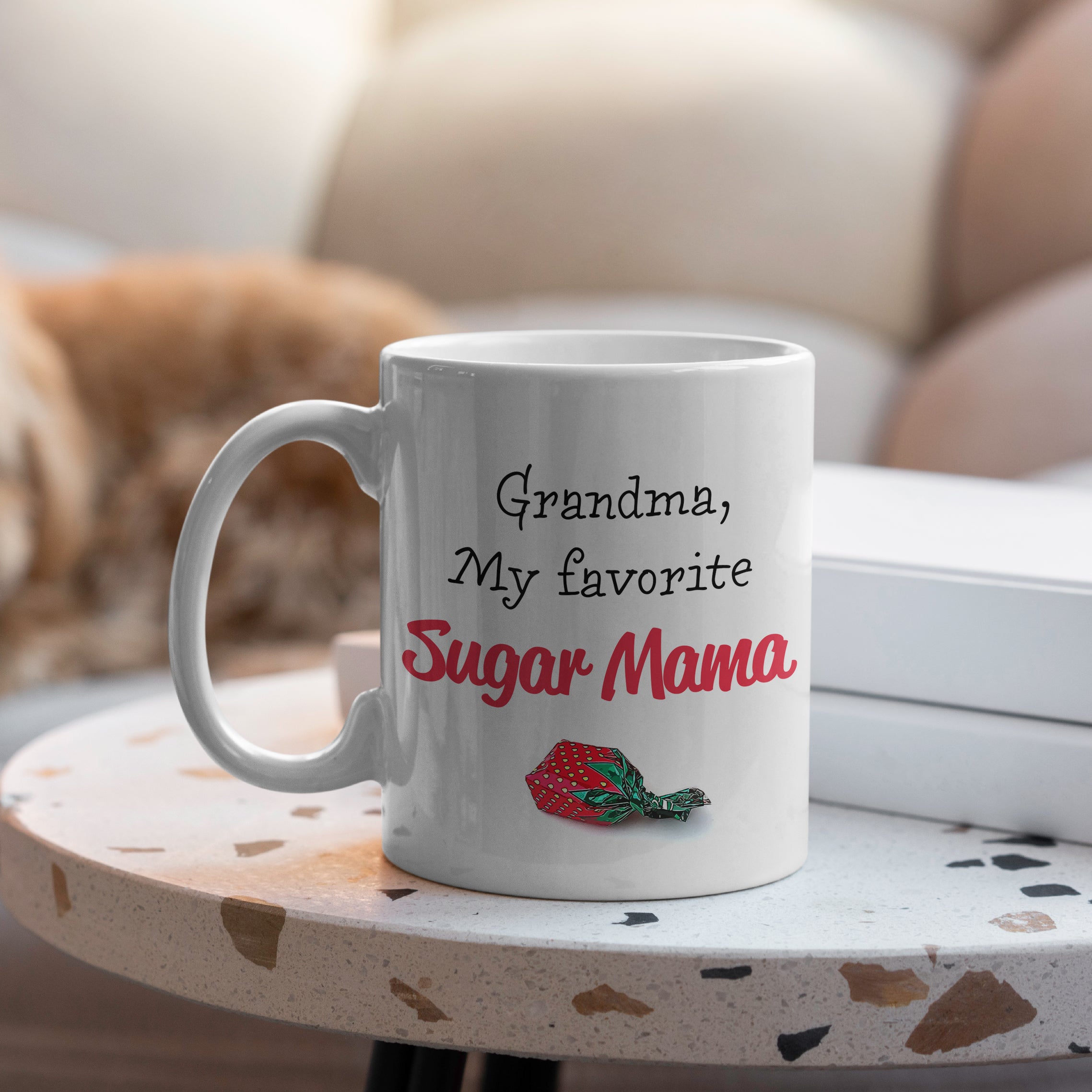 White ceramic grandma mug on table with Sugar Mama strawberry candy design