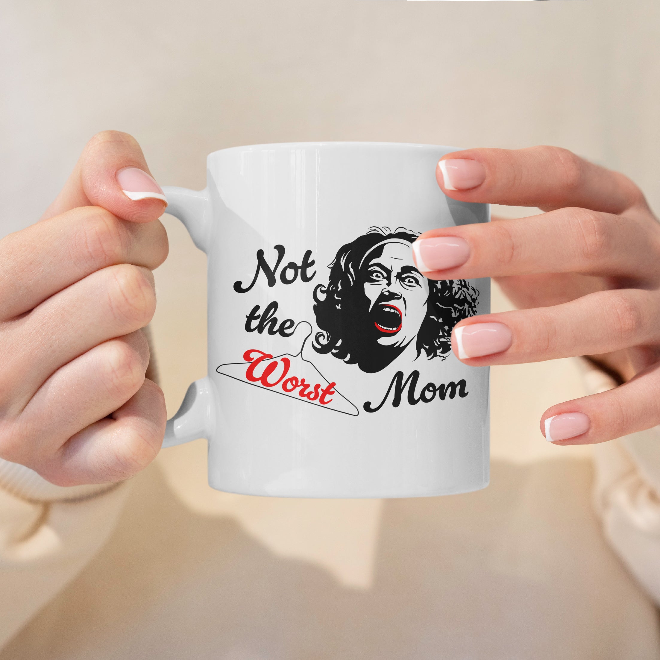White ceramic mug with black and red illustration of Joan Crawford inspired Mommie Dearest on table
