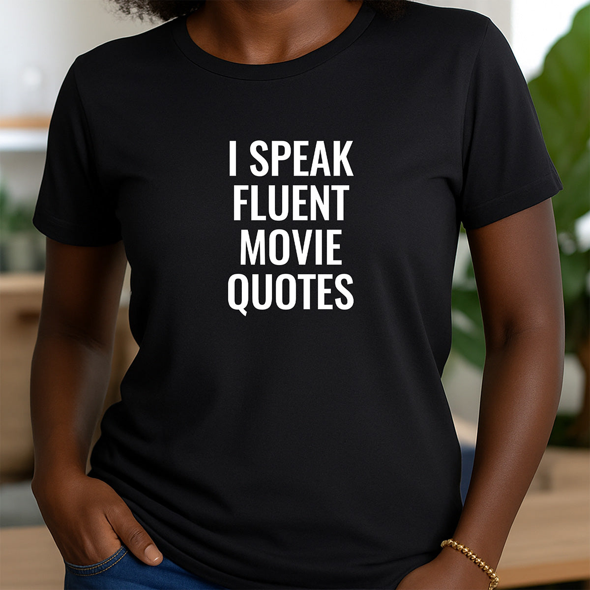 Women’s black crewneck t-shirt with bold white text I Speak Fluent Movie Quotes