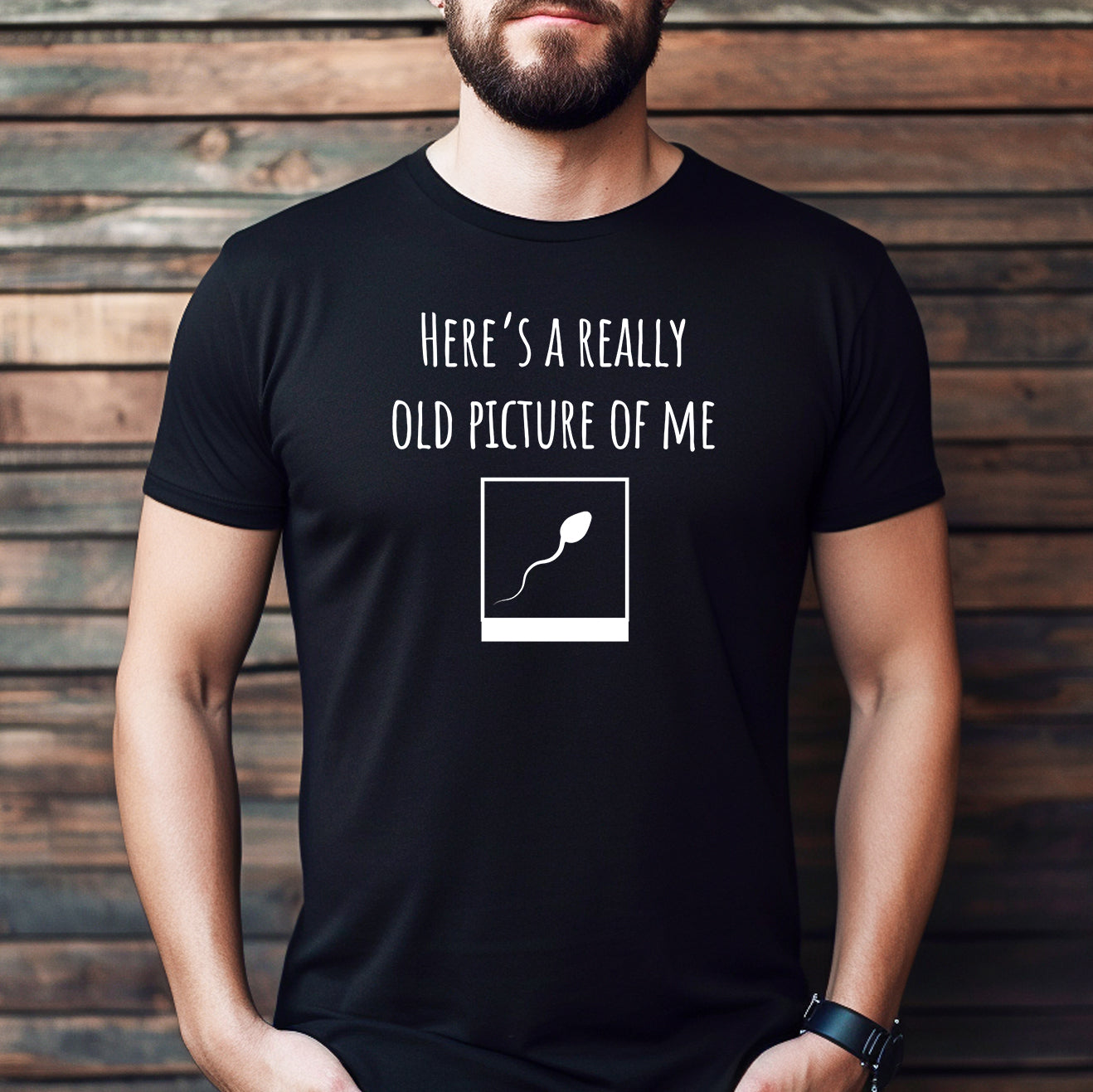 Man wearing black t-shirt with here's a really old picture of me and sperm design