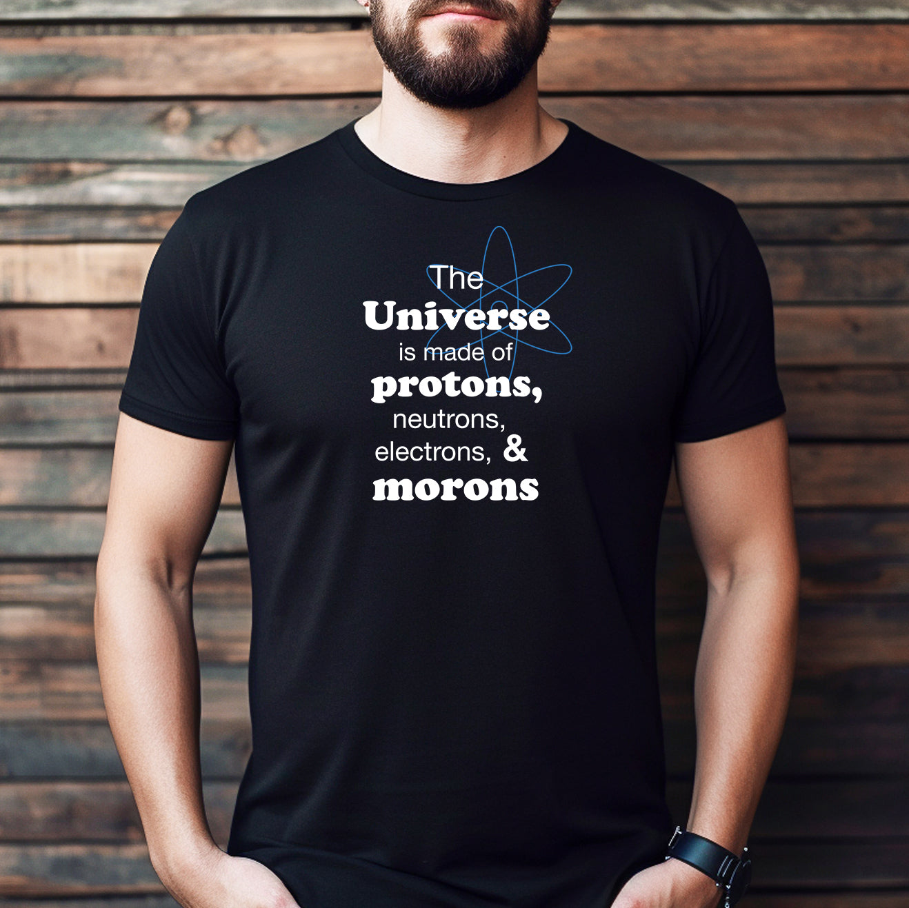 Man wearing funny physics t-shirt that says The Universe is made of protons, neutrons, electrons, & morons in white print