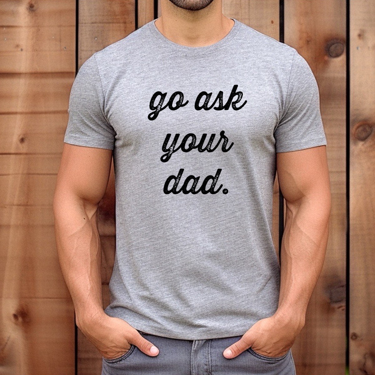 Man wearing heather gray t-shirt with go ask your dad script text, casual outdoor lifestyle