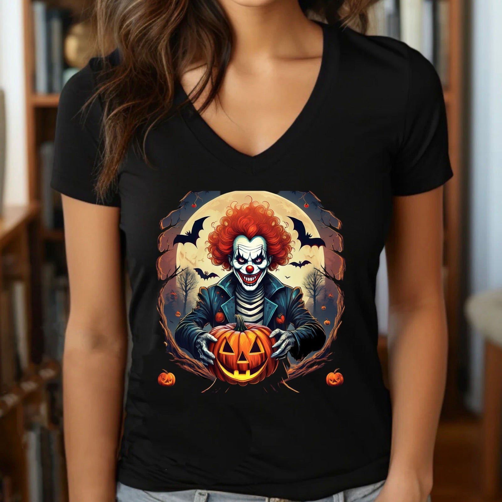 Women’s v-neck black t-shirt showcasing a spooky clown with red hair holding a glowing pumpkin for Halloween