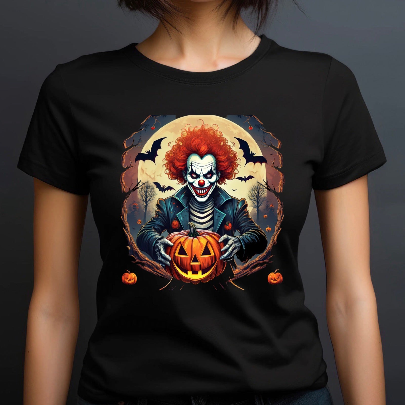 Women’s black t-shirt with a horror clown holding a jack-o’-lantern pumpkin under a full moon with flying bats.