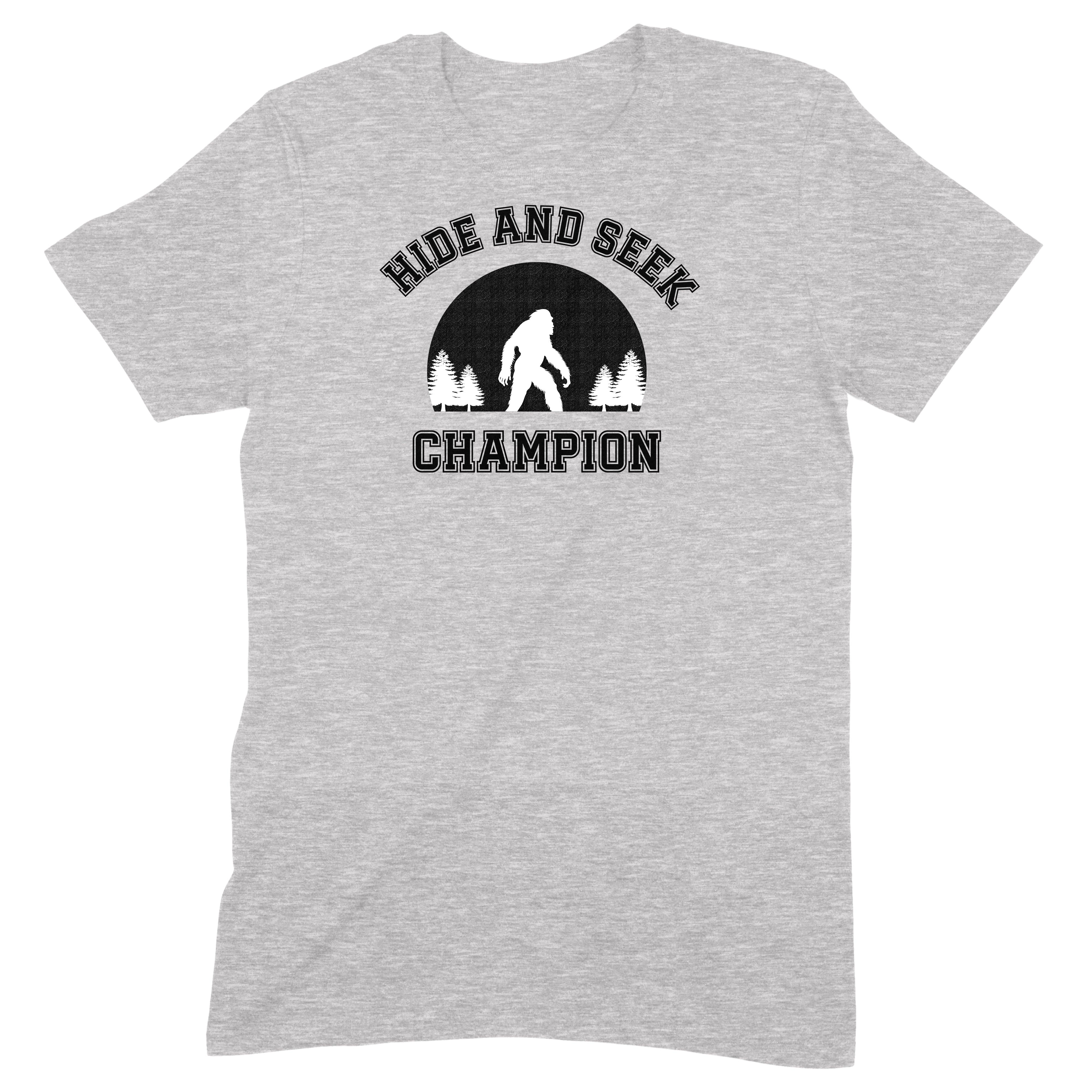 Flat lay grey t-shirt with Hide and Seek Champion design featuring Bigfoot silhouette and trees