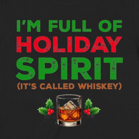 Closeup of holiday whiskey spirit t-shirt with bold red and green text and whiskey glass with holly leaves