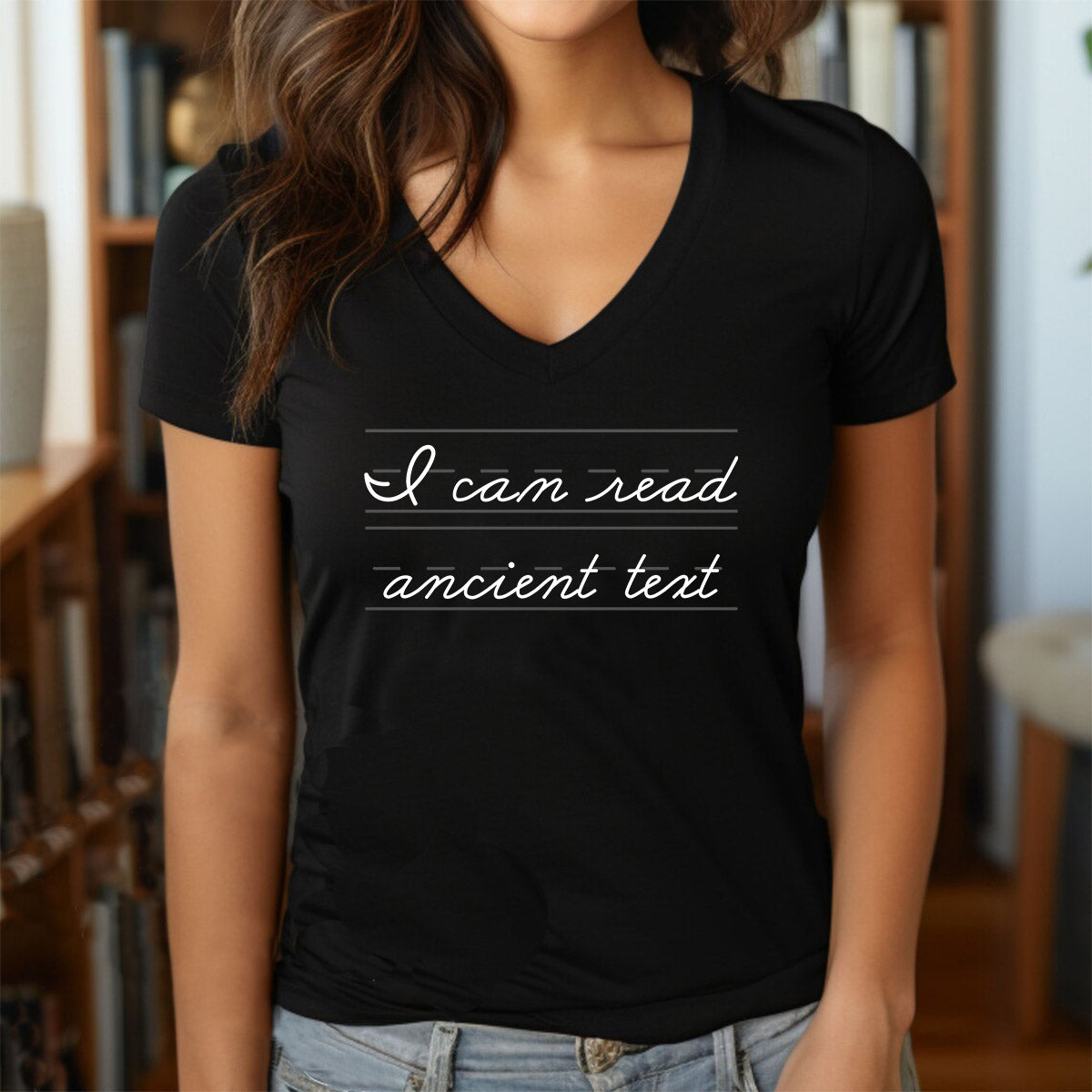 Woman in black v-neck t-shirt with cursive text “I can read ancient text” written in handwriting style.