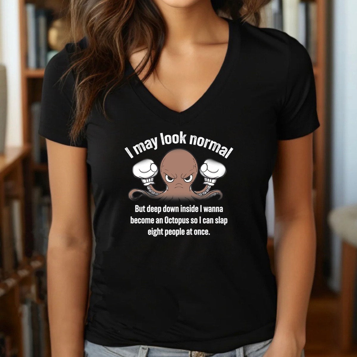 Woman wearing black v-neck t-shirt with angry octopus cartoon and I may look normal funny quote, indoor lifestyle