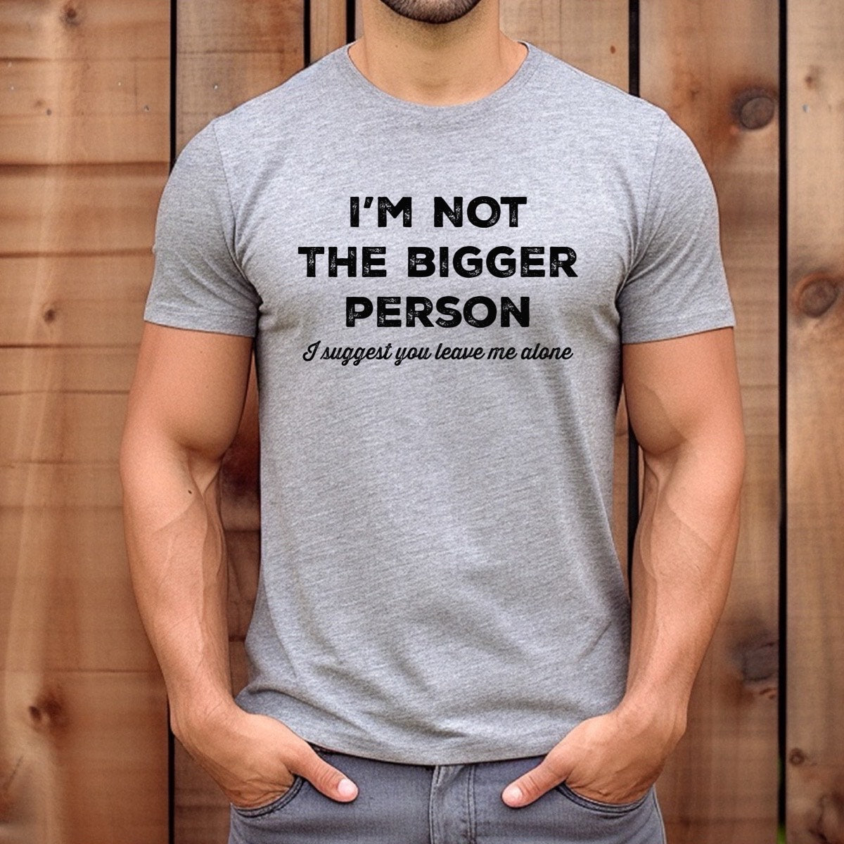 Man wearing heather gray t-shirt reading I’m not the bigger person, I suggest you leave me alone, casual outdoor lifestyle