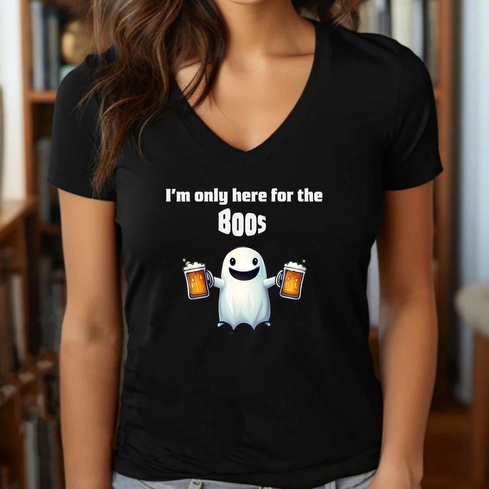 woman wearing black v neck halloween shirt with ghost holding beer mugs and the text im only here for the boos