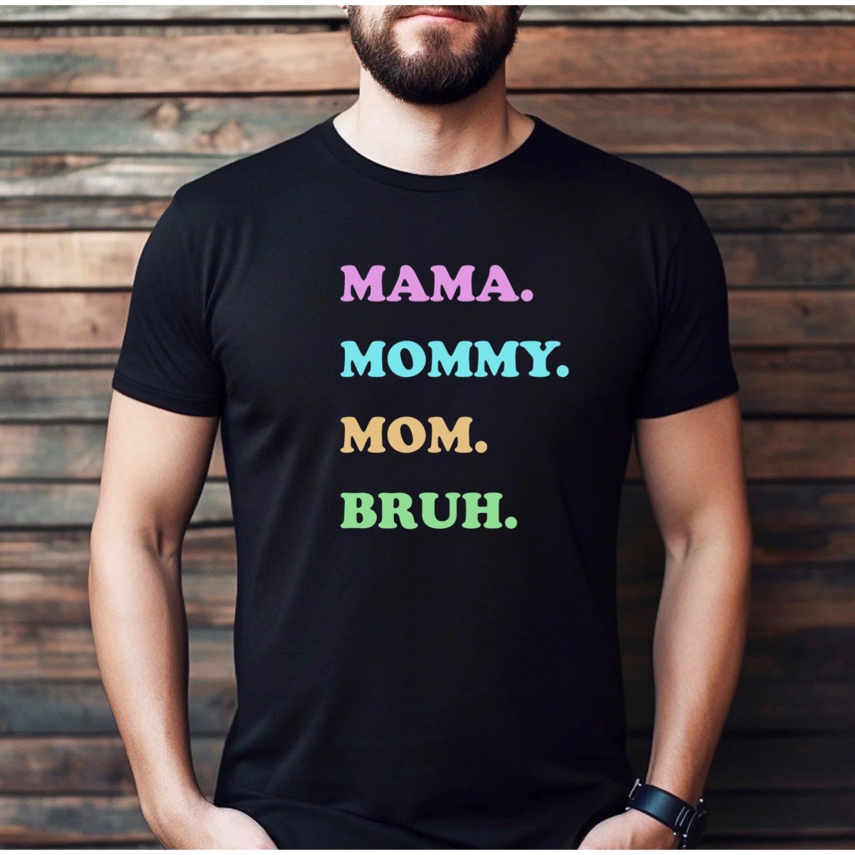 Man wearing black t-shirt with pastel Mama Mommy Mom Bruh text, humorous mom quote tee