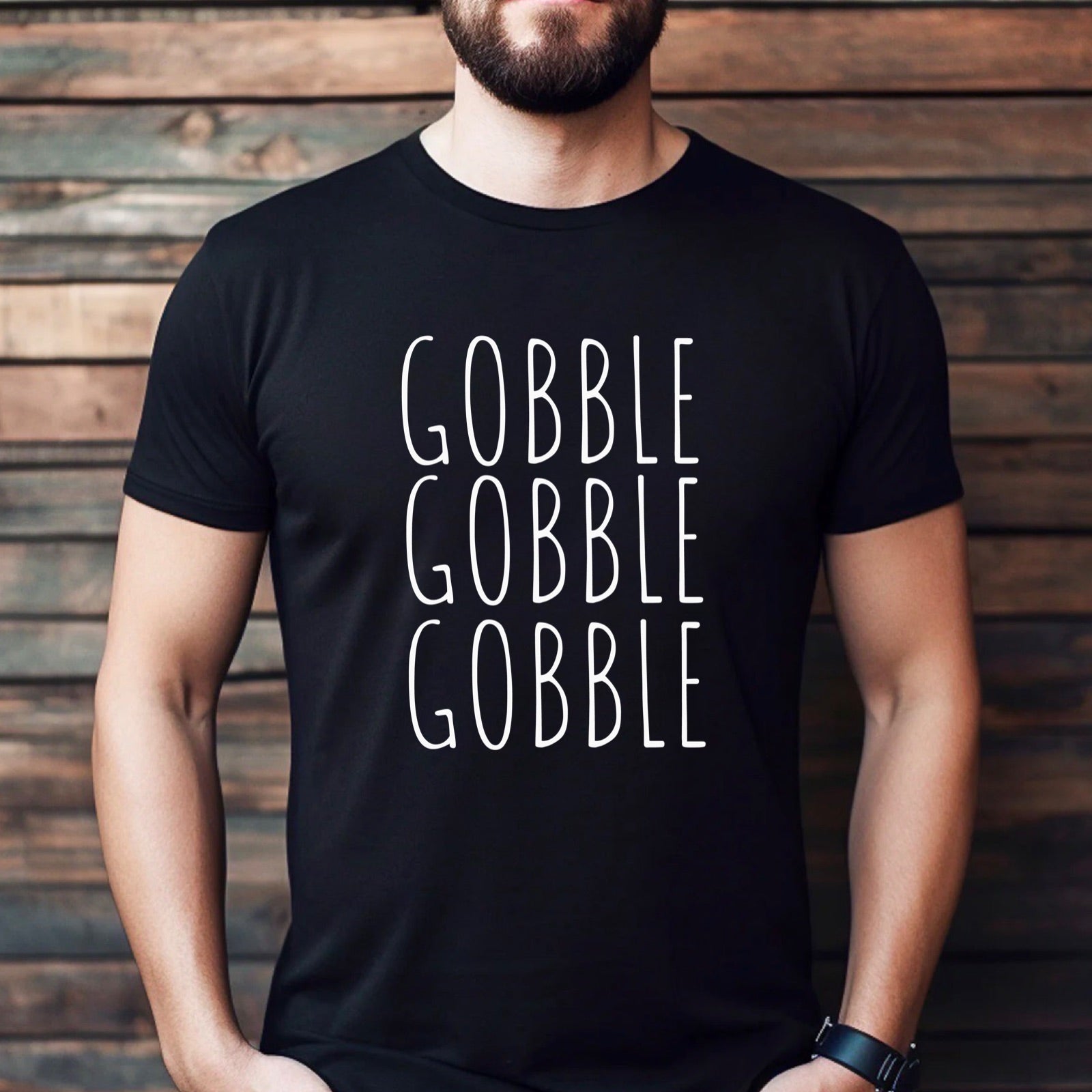 Man wearing black t-shirt with white Gobble Gobble Gobble Thanksgiving design