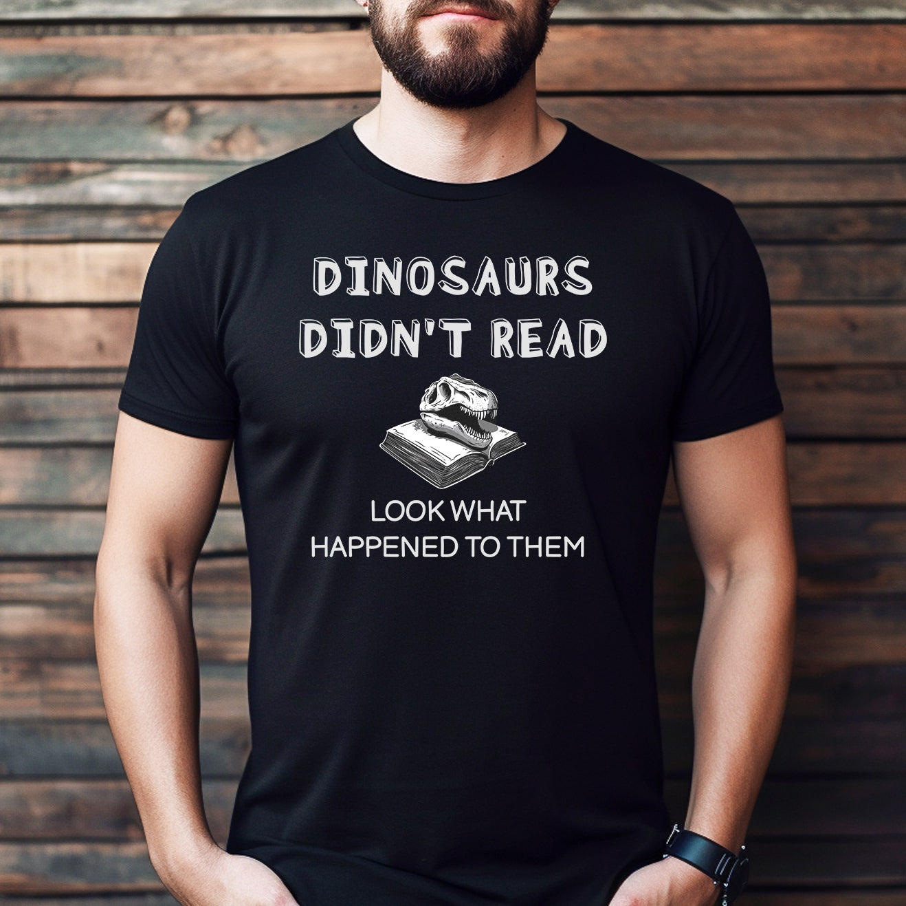Man wearing black crew neck t-shirt with Dinosaurs Didn’t Read text and dinosaur skull on book design