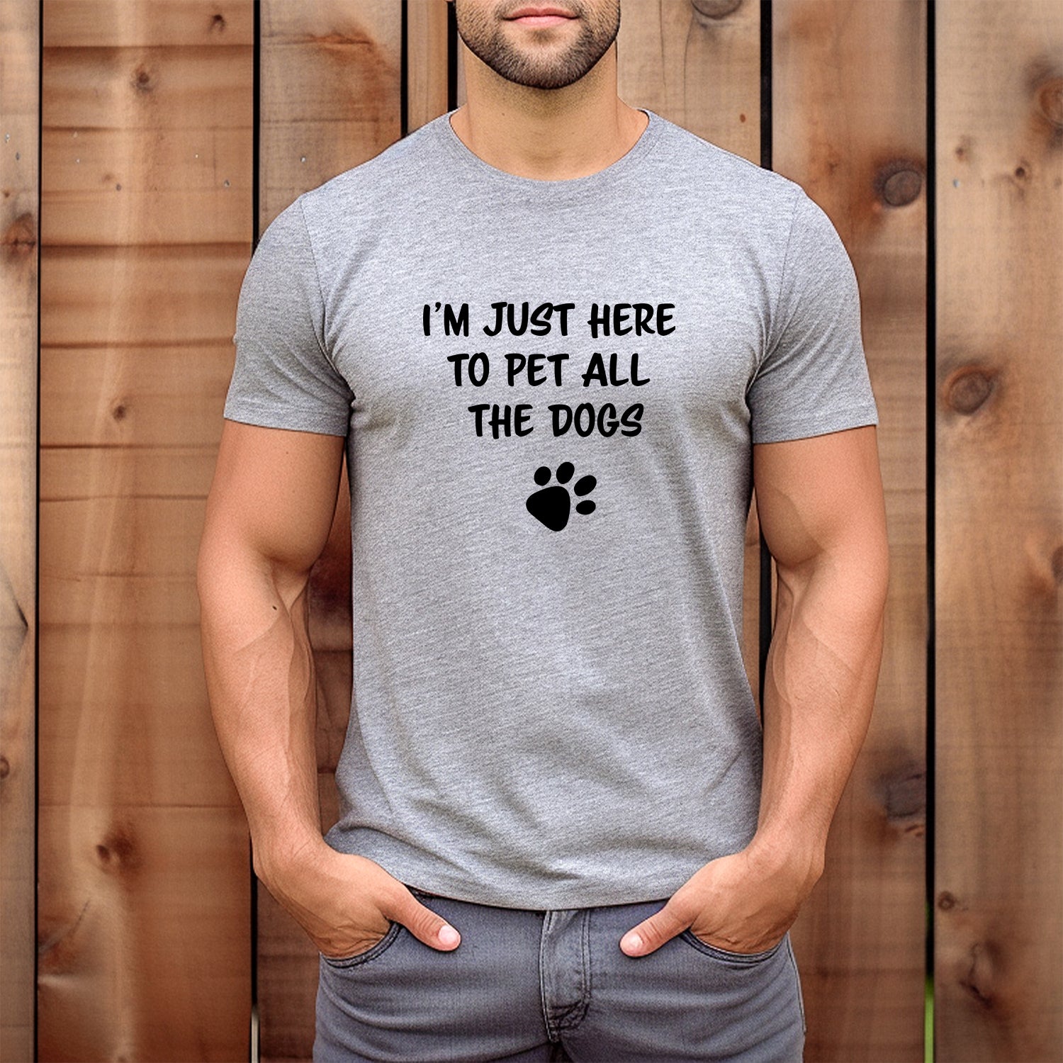 Man wearing grey T-shirt with text I’m Just Here to Pet All the Dogs and paw print