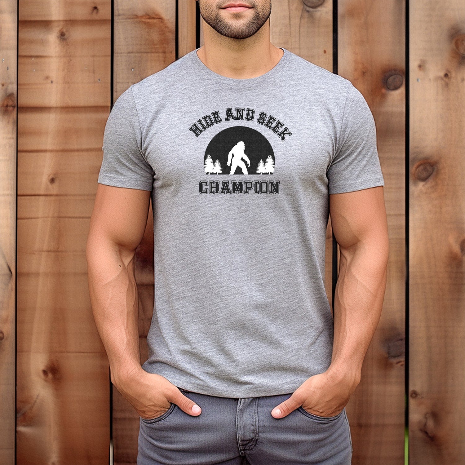 Men’s grey t-shirt with Hide and Seek Champion slogan and Bigfoot forest silhouette design