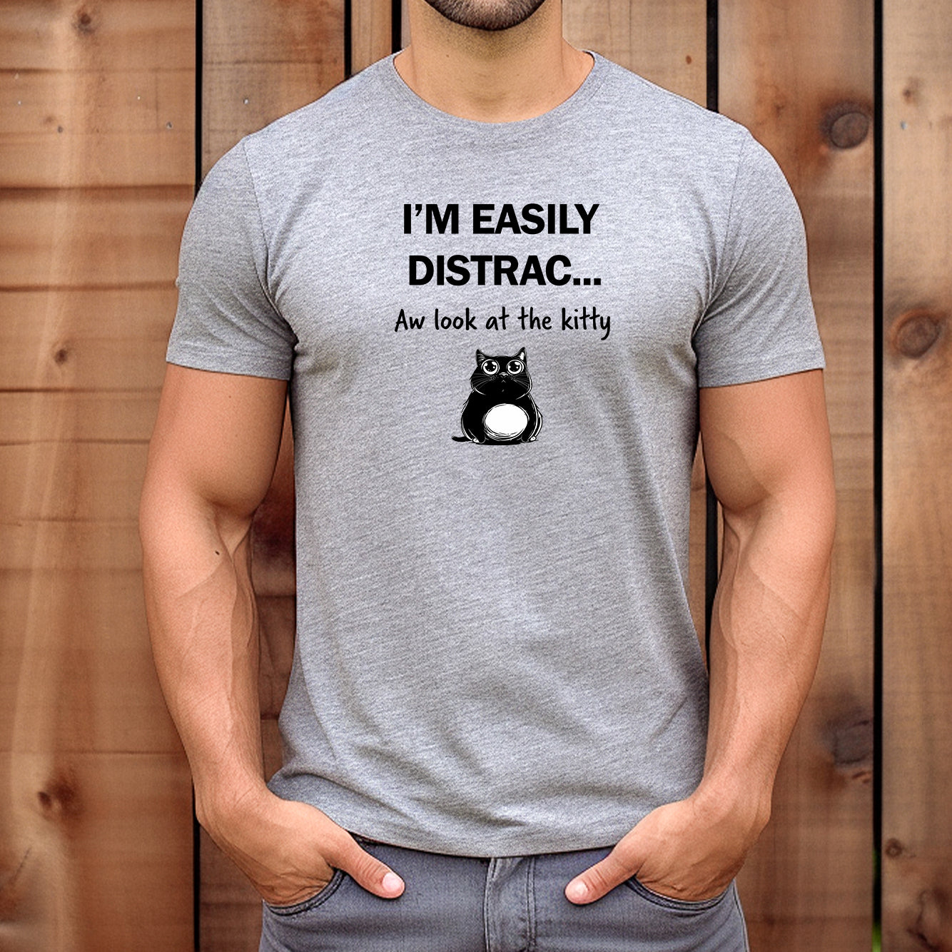 Man wearing gray t-shirt with funny cat design and text I'm easily distracted look at the kitty