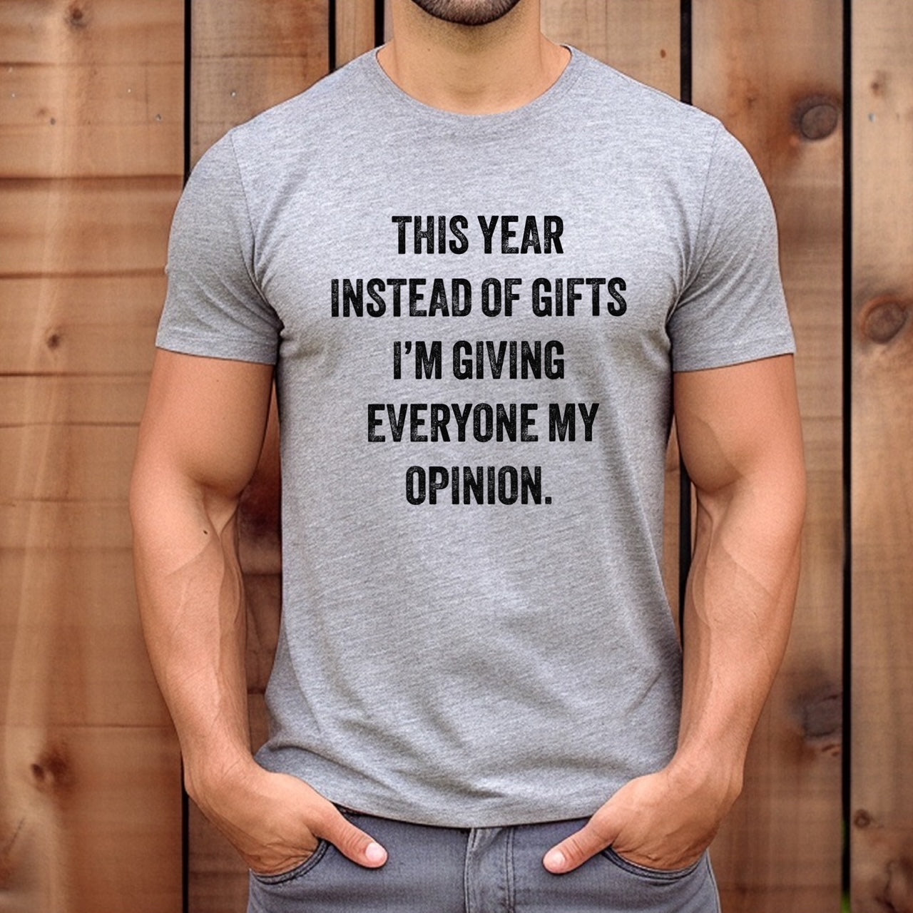 Man wearing grey crewneck t-shirt with text this year instead of gifts I'm giving everyone my opinion