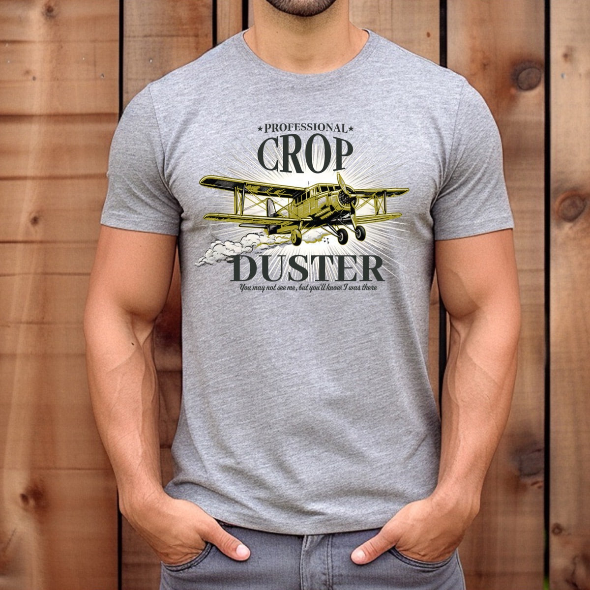 Man wearing grey crop duster airplane graphic t-shirt with funny professional crop duster text